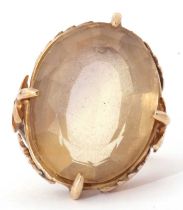 Large lemon citrine dress ring, the oval faceted citrine in cardinal set and raised between chased