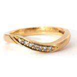 Modern seven stone diamond ring, an angular design set with seven small round cut diamonds,