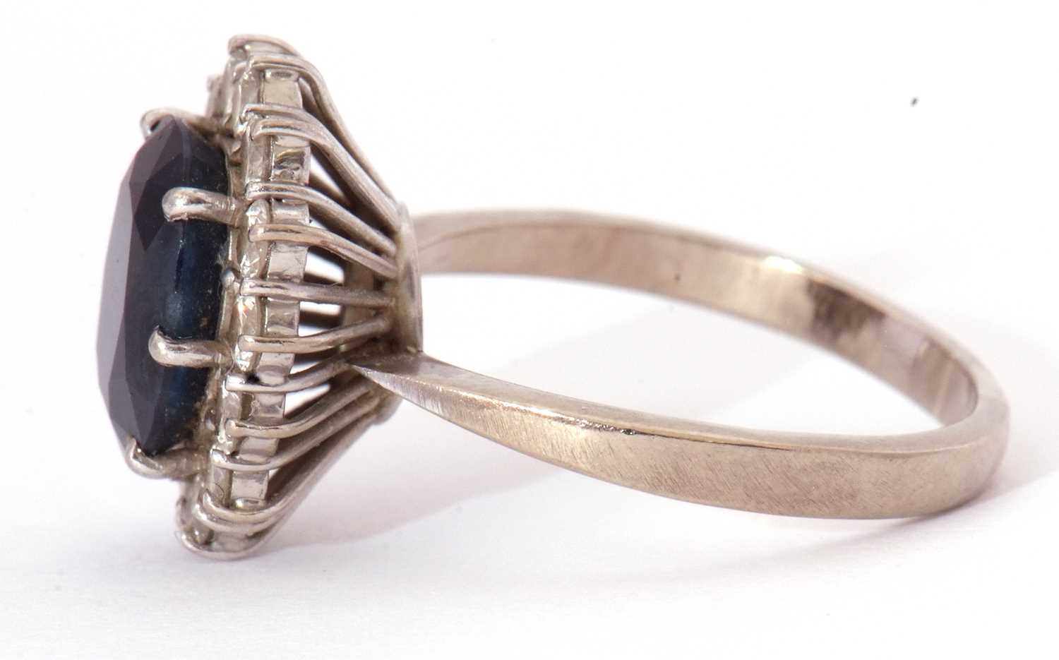 18ct white gold, dark sapphire and diamond ring, the oval faceted sapphire is 10x8mm, raised above a - Image 3 of 8