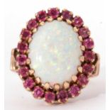 Large opal and ruby dress ring, the oval shaped cabochon opal 16x13 mm, multi claw set and raised