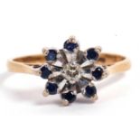 Sapphire and diamond flower head ring centering a small brilliant cut diamond surrounded by eight
