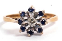 Sapphire and diamond flower head ring centering a small brilliant cut diamond surrounded by eight