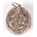 Large vintage Indian white metal locket of oval form, twin sided and embossed and chased with