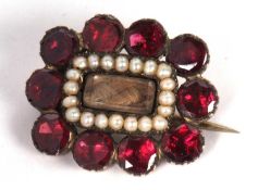 Antique mourning brooch the centre glazed panel with plaited hair framed within seed pearl surround,