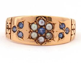 Antique 18ct gold sapphire and pearl ring centering a seed pearl and sapphire set flower head