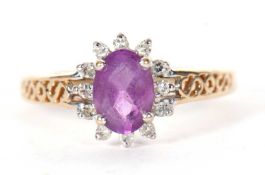 Modern 9ct gold amethyst and diamond cluster ring, the oval faceted amethyst raised above a small