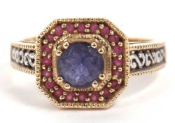 Modern 9ct gold blue and red stone dress ring, the round faceted blue centre stone raised within a