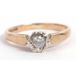 9ct gold single stone diamond ring, the small round brilliant cut diamond illusion set and raised