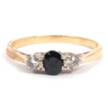 18ct gold sapphire and diamond three stone ring, the oval faceted sapphire set between two small