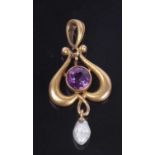 Small Art Nouveau style open work pendant centering a round cut faceted amethyst, suspending a small