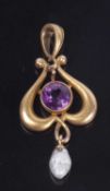 Small Art Nouveau style open work pendant centering a round cut faceted amethyst, suspending a small