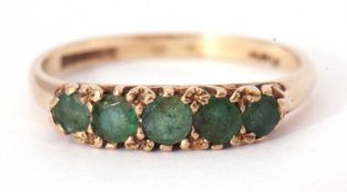 9ct gold emerald ring, line set, set with five graduated round cut emeralds all in a carved