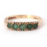 9ct gold emerald ring, line set, set with five graduated round cut emeralds all in a carved