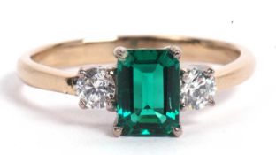 Green stone and diamond ring the central step cut green stone flanked by two brilliant cut