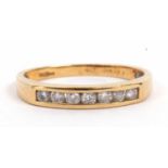 18ct gold diamond ring featuring seven small round channel set diamonds, total diamond ct weight app