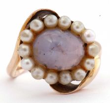 9ct gold star sapphire and seed pearl ring, the cabochon sapphire set within a surround of small