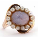 9ct gold star sapphire and seed pearl ring, the cabochon sapphire set within a surround of small