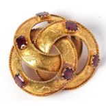 Antique high-grade yellow metal amethyst set brooch, a design with three entwined circles each