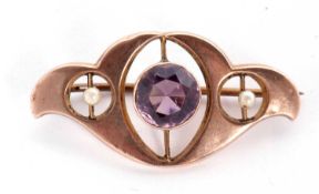 Amethyst and seed pearl set brooch in the art nouveau style centering a round faceted amethyst
