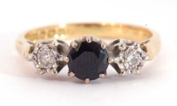 18ct gold sapphire and diamond three stone ring, the round cut sapphire between two small illusion