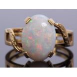 Large opalescent dress ring four claw set and raised between pieced, chased and engraved crossover