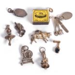 Mixed lot of charms to include a 9ct gold framed and enameled match box together with seven