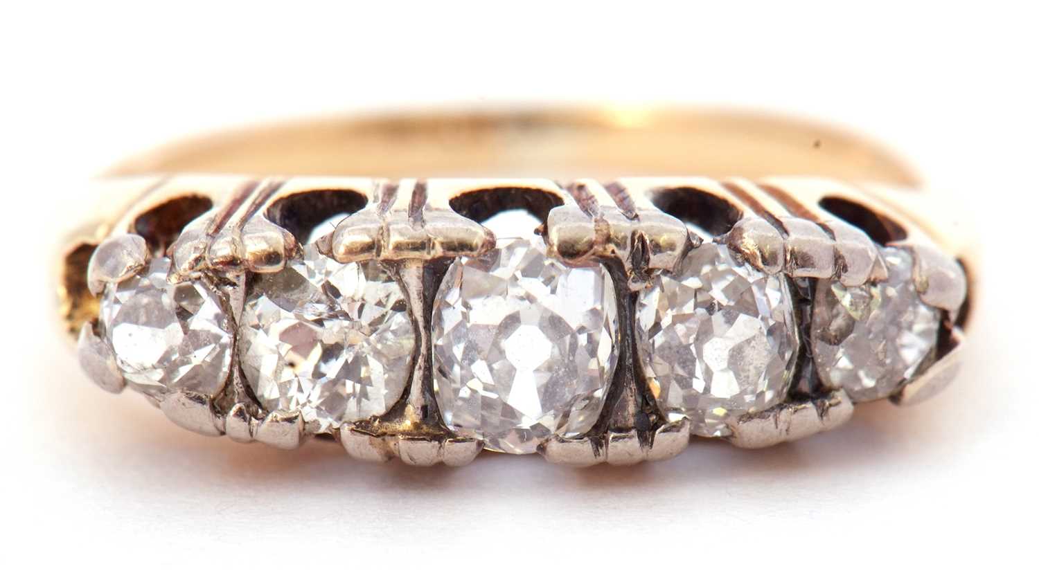 Antique 5 stone diamond ring featuring five old cut diamonds individually claw set in a pierced