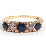 Sapphire and diamond five stone ring having three graduated round sapphires and two old cut diamonds