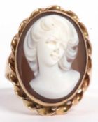 A cameo ring, the oval panel carved with a raised head and shoulders profile of a lady, bezel set in