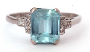 Aquamarine and diamond ring, a stepped cut aquamarine raised between small diamond highlighted