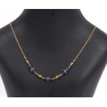 Modern crystal bead necklace, a design featuring three cone shaped crystal beads set between four