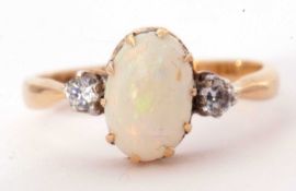 18ct gold opal and diamond ring, the cabochon oval cut opal multiclaw set between two small old