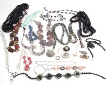A large box of mainly jet and vulcanite jewellery to include brooches, necklaces, pendants etc