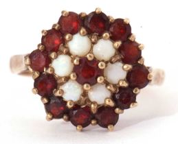 Garnet and opal cluster ring, a flower head design with thirteen small garnets and five small