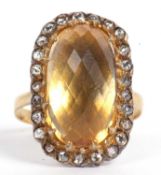Citrine and diamond dress ring, the large faceted lemon coloured cushion shaped citrine 16x10mm, set