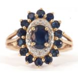 Modern 9ct gold sapphire and diamond cluster ring, the panel centres an oval cut sapphire within a