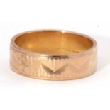 9ct gold wedding band chased and engraved with a geo-metric design, g/w 3.4gms, size L-M