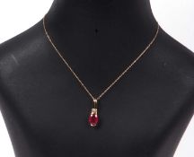 Ruby and diamond pendant, the oval faceted ruby is 1.35ct approx, highlighted above with two small