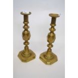 Pair of brass candlesticks, one entitled 'The King of Diamonds', 31cm high