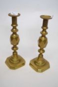 Pair of brass candlesticks, one entitled 'The King of Diamonds', 31cm high