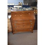 George III oak bureau of typical form, the full front opening to an interior with pigeon holes and