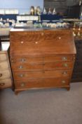 George III oak bureau of typical form, the full front opening to an interior with pigeon holes and