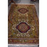 20th Century Middle Eastern wool floor rug decorated with large central lozenges, stylised floral