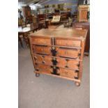 Chest of drawers with wooden ebonised borders to the drawers and around the central escutcheon