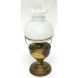 A small brass oil lamp with shade