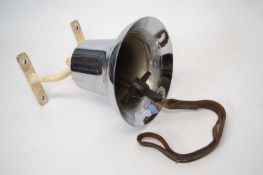 Silver coloured ships bell with cast iron mount