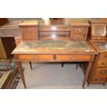 Late 19th or early 20th Century rosewood writing table, the top with shelves, brass gallery and four