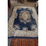 Large 20th Century Chinese wool floor rug decorated with stylised foliage on a blue and cream