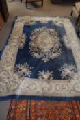 Large 20th Century Chinese wool floor rug decorated with stylised foliage on a blue and cream