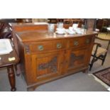 Late Victorian bow front side board with two drawers and two doors with carved stylised